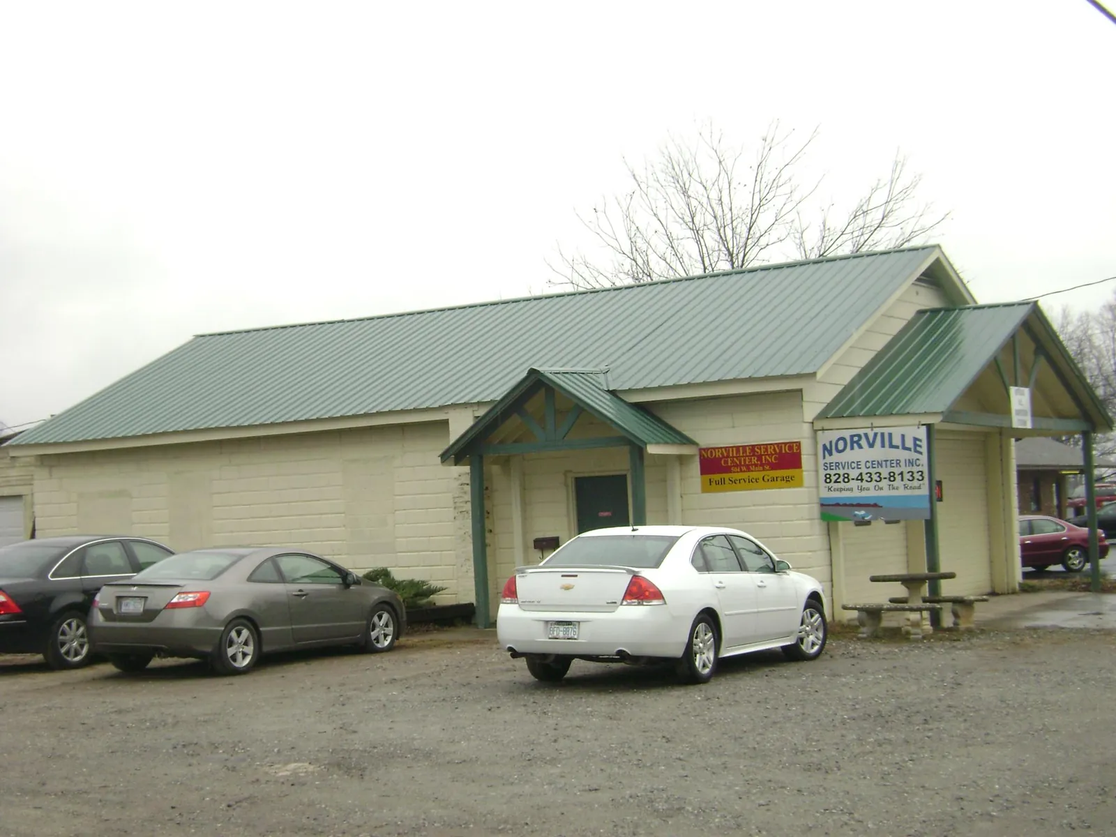 Green metal roof on a service garage with a covered entry in Ripley